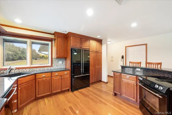a kitchen with stainless steel appliances granite countertop a stove and a refrigerator