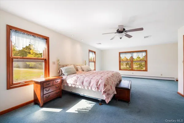 a spacious bedroom with a bed and a window