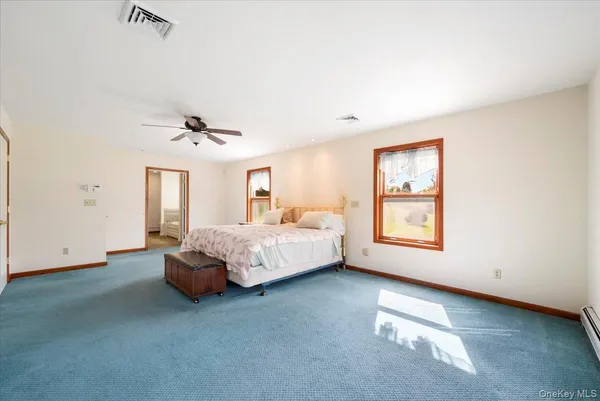 a spacious bedroom with a bed and a window