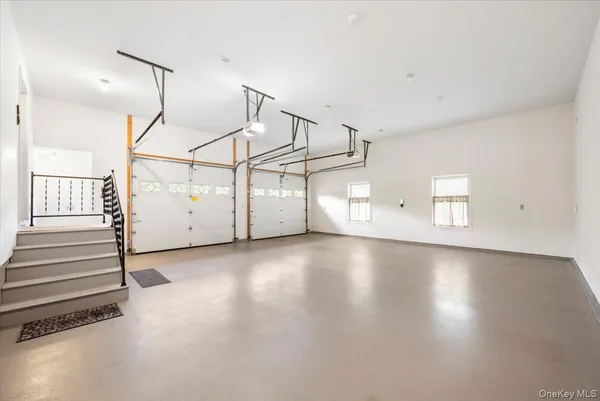 a view of a room with stairs and white walls