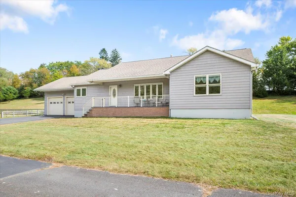 a front view of house with yard and swimming pool