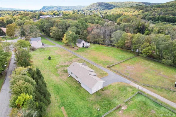 an aerial view of a house with a yard