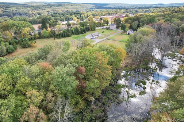 an aerial view of a houses with a yard