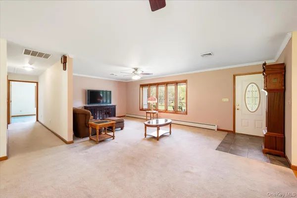 a living room with furniture window and flat screen tv