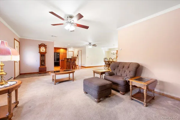 a living room with furniture and a ceiling fan