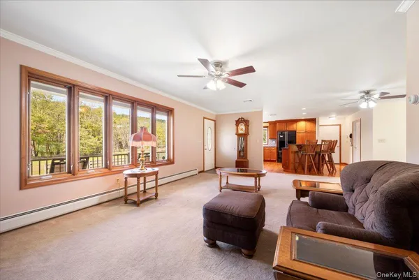 a living room with furniture and a large window with outer view