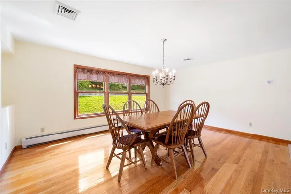 a view of a dining room with furniture window and wooden floor