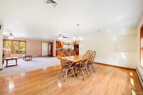 a view of a dining room with furniture window and wooden floor