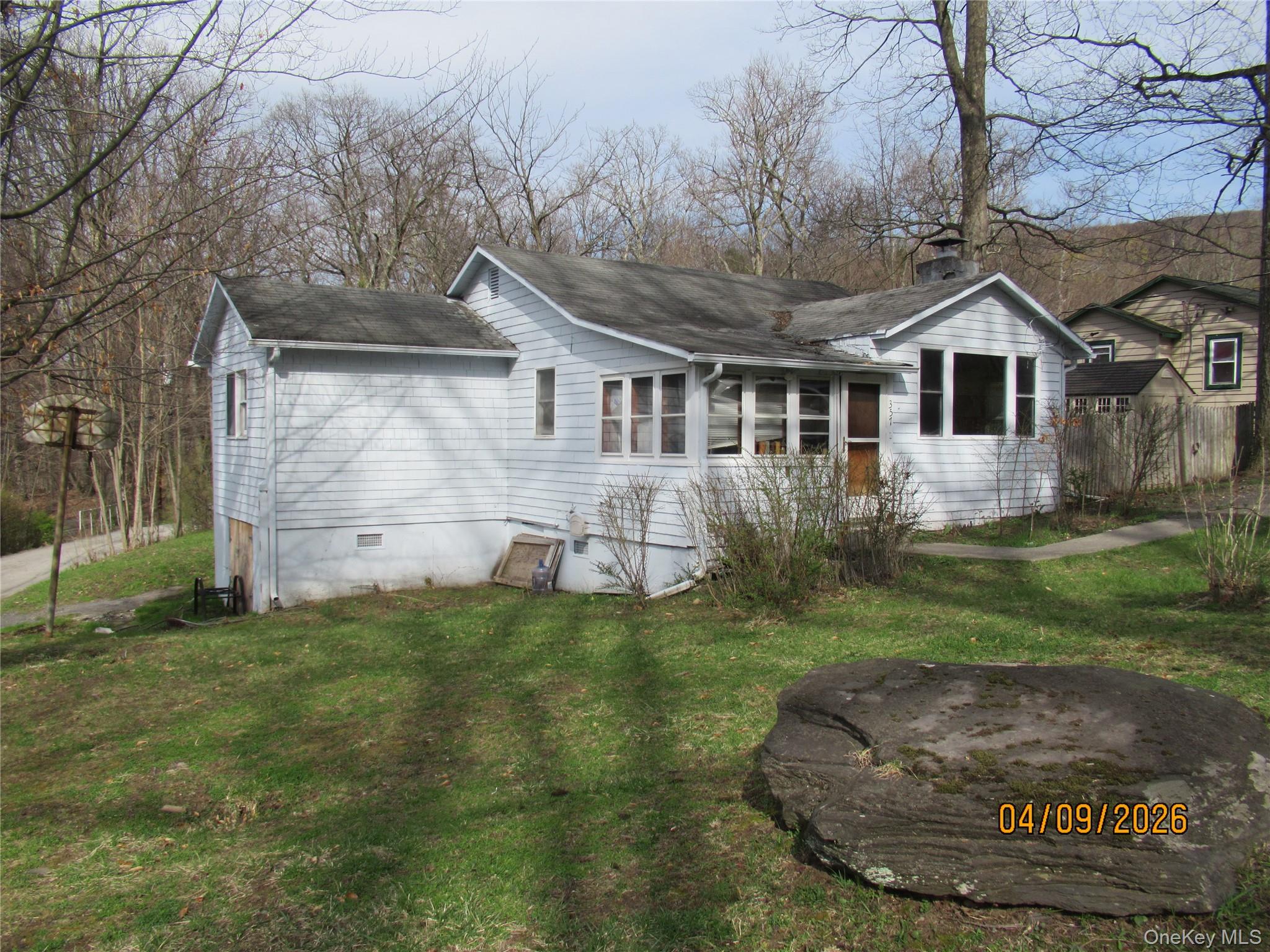 357 Mountain Lodge Road Monroe, NY 10950 - Photo 14 of 20 The property features a white exterior, a well-maintained lawn, and established trees