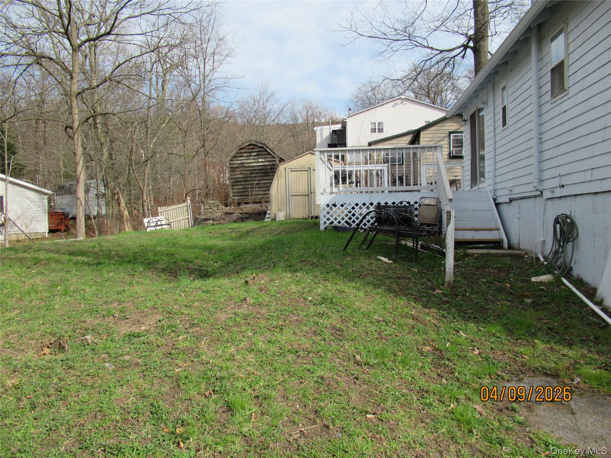 357 Mountain Lodge Road Monroe, NY 10950 - Photo 15 of 20 The property features an extensive lawn area and a wooden deck with railing