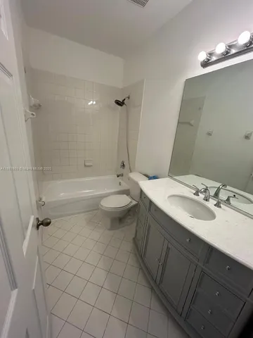 a utility room with cabinets washer and dryer