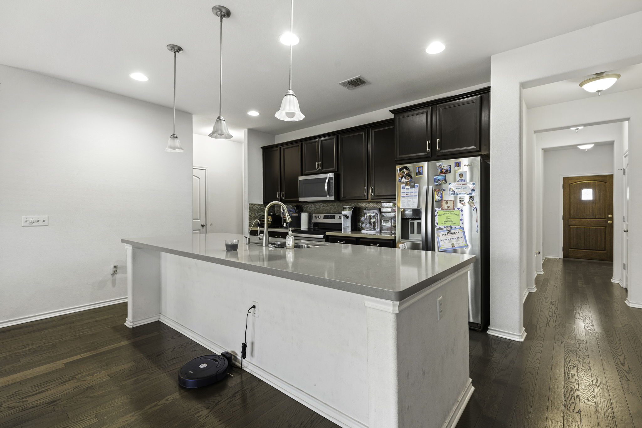 3116 Bragg Place Pflugerville, TX 78660 - Photo 6 of 29 a kitchen with stainless steel appliances a sink stove and refrigerator
