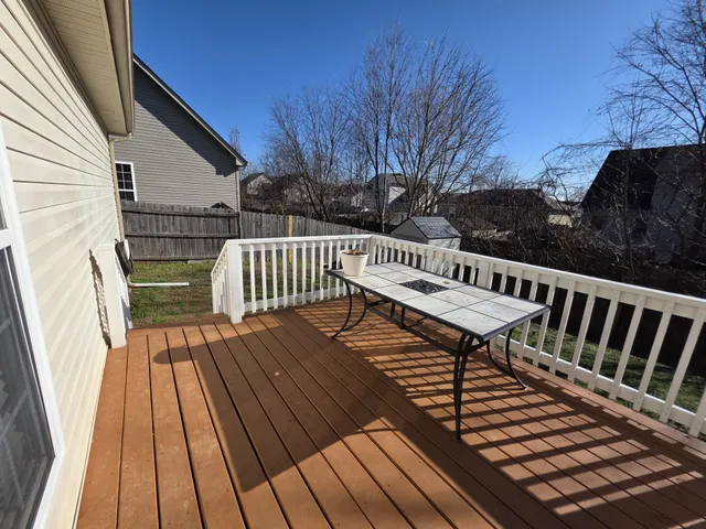 a view of balcony with wooden floor and outdoor seating