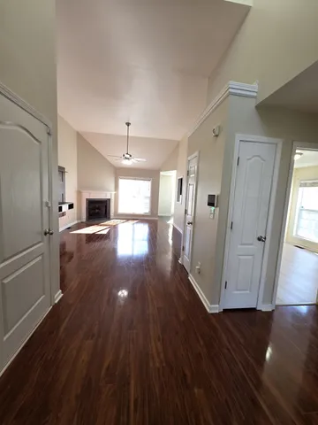 a view of a kitchen with wooden floor and electronic appliances