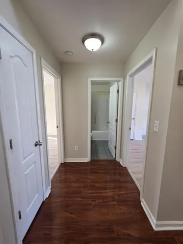 a bedroom with a bed and hardwood floor