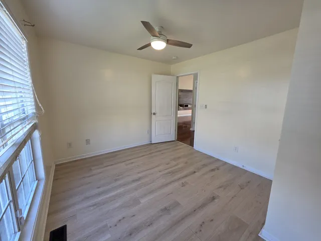 a view of an empty room and wooden floor