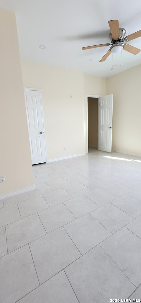 118 Grass Valley Road, Unit 201 Eagle Pass, TX 78852 - Photo 7 of 26 an empty room with a empty space and a ceiling fan