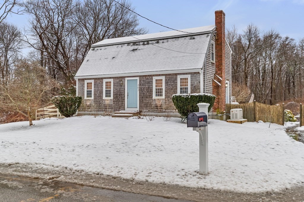 a view of a house with a yard covered in snow