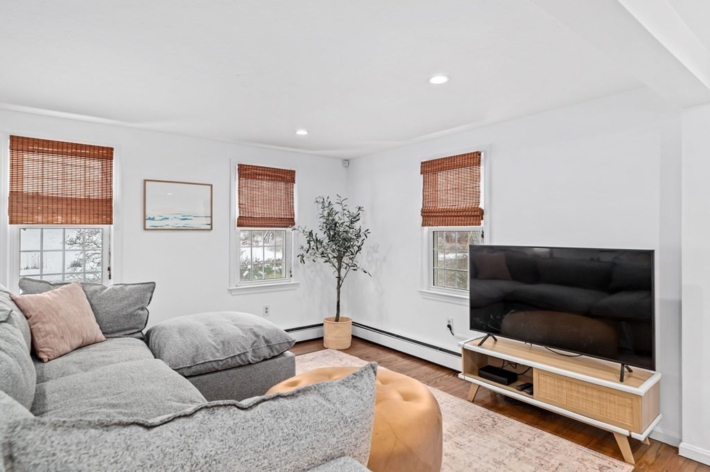 207 Tilden Road Scituate, MA 02066 - Photo 12 of 42 a living room with furniture and a flat screen tv