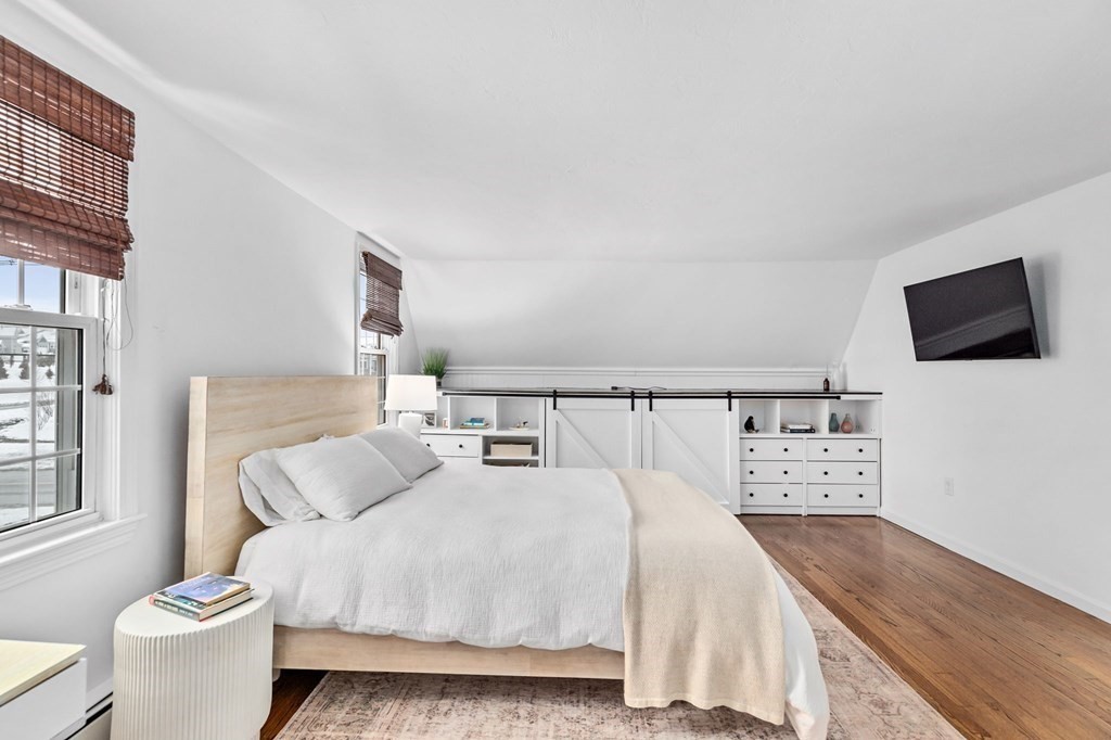 207 Tilden Road Scituate, MA 02066 - Photo 25 of 42 a bedroom with a bed and a flat screen tv