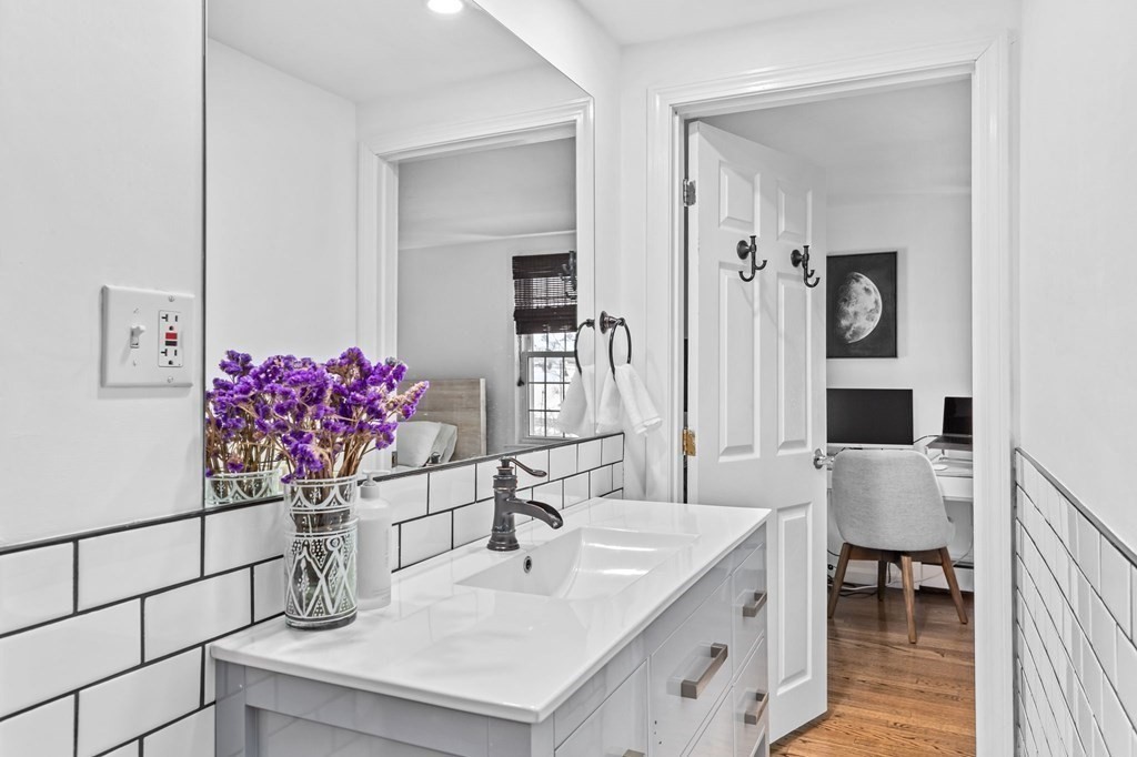 207 Tilden Road Scituate, MA 02066 - Photo 28 of 42 a bathroom with a sink and a mirror