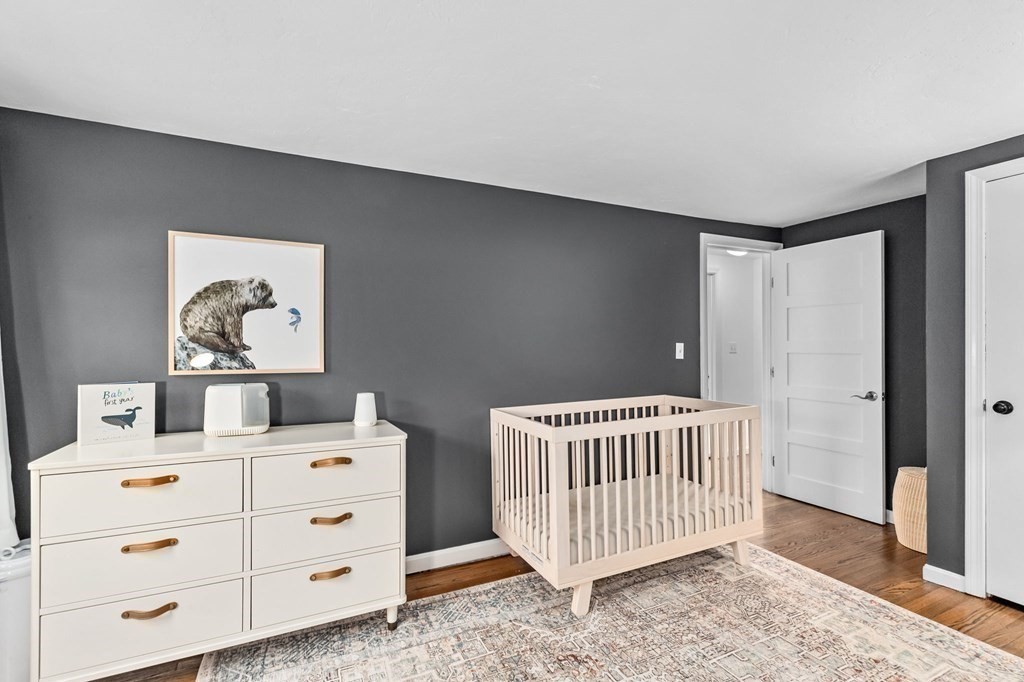 207 Tilden Road Scituate, MA 02066 - Photo 32 of 42 a bedroom with a bed and wooden floor