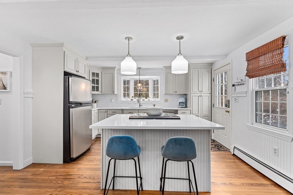 207 Tilden Road Scituate, MA 02066 - Photo 4 of 42 a kitchen with kitchen island a counter top space appliances and cabinets
