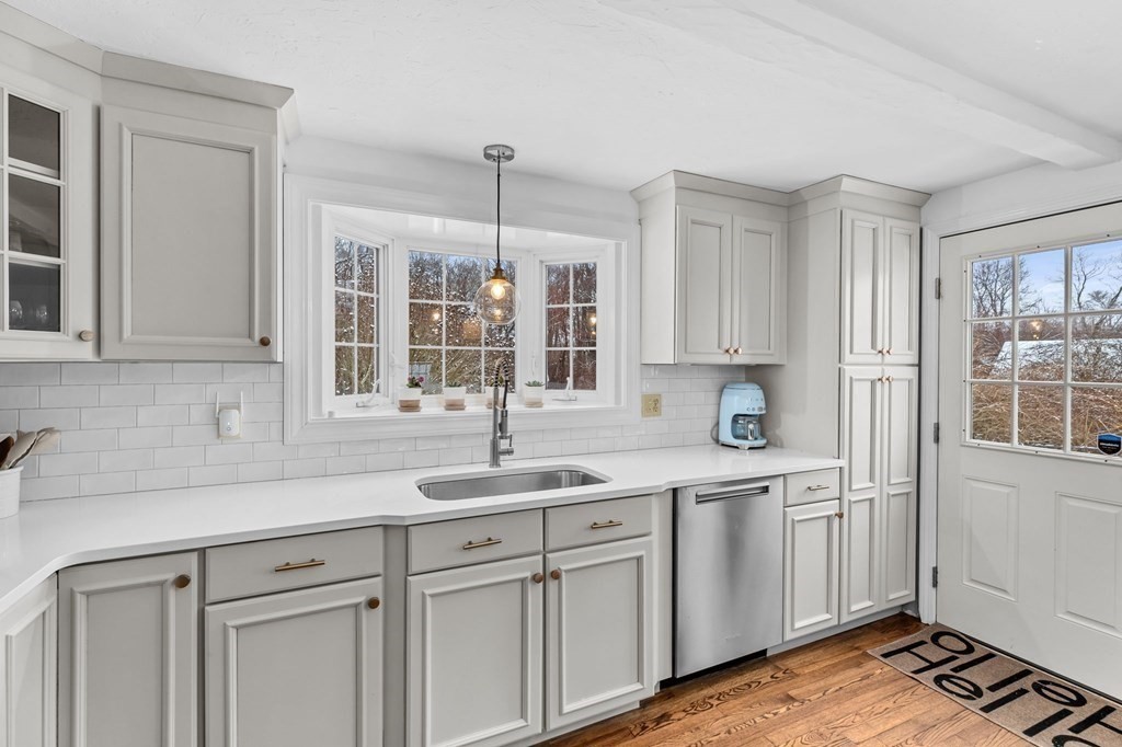 207 Tilden Road Scituate, MA 02066 - Photo 5 of 42 a kitchen with white cabinets and sink