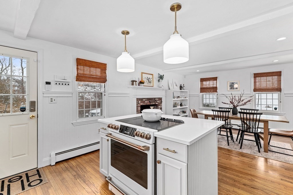 207 Tilden Road Scituate, MA 02066 - Photo 7 of 42 a kitchen with a stove and a wooden floor