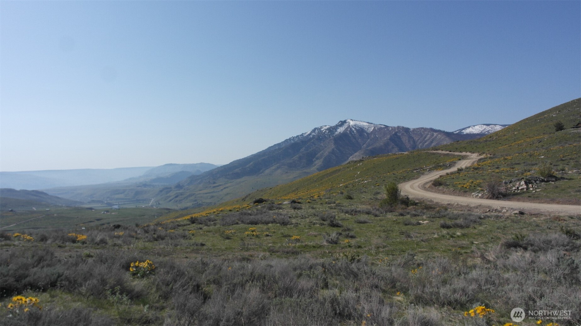 31 Cowboy Road Pateros, WA 98846 - Photo 5 of 38 a view of a field with mountains in the background