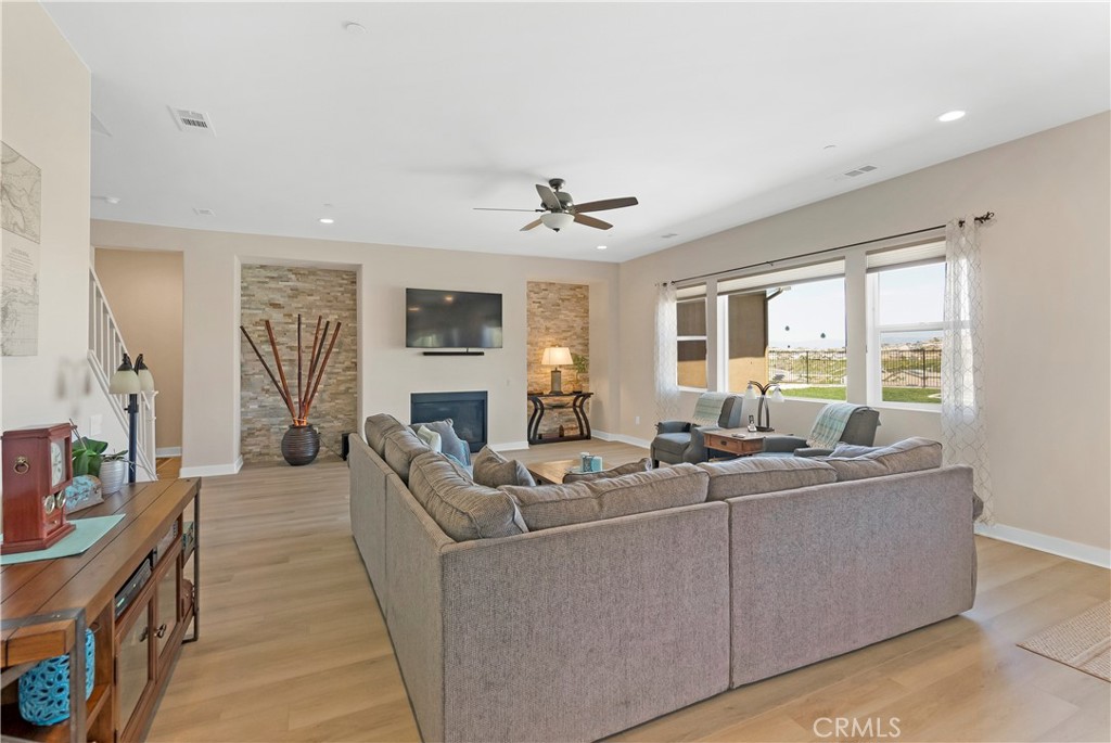 13500 Gold Medal Court Riverside, CA 92503 - Photo 15 of 48 a living room with furniture a large window and a chandelier