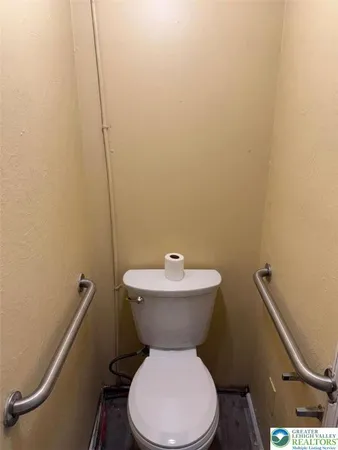 a white toilet sitting next to a bathroom sink