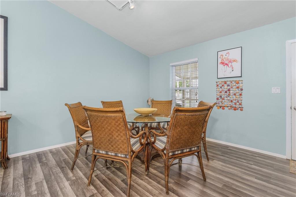 1281 10th Street North Naples, FL 34102 - Photo 11 of 31 Dining room with wood finished floors and vaulted ceiling