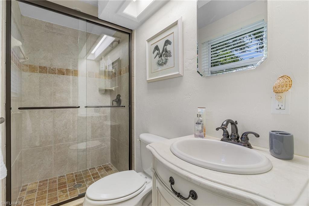 1281 10th Street North Naples, FL 34102 - Photo 18 of 31 Full bath with vanity and a stall shower
