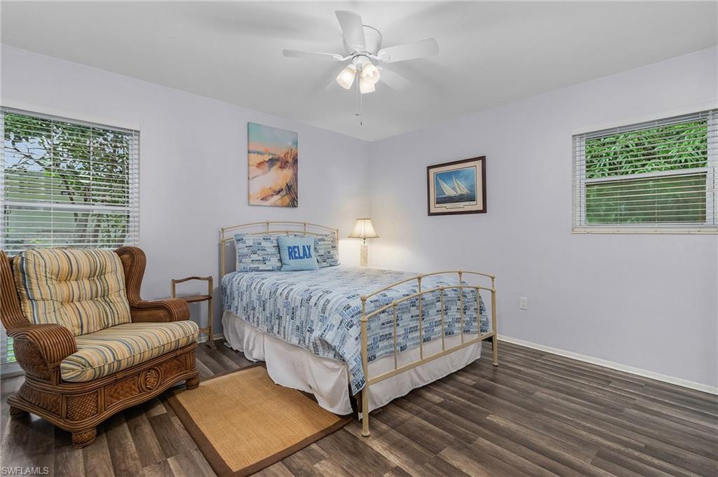 1281 10th Street North Naples, FL 34102 - Photo 19 of 31 Bedroom with multiple windows, wood finished floors, and a ceiling fan