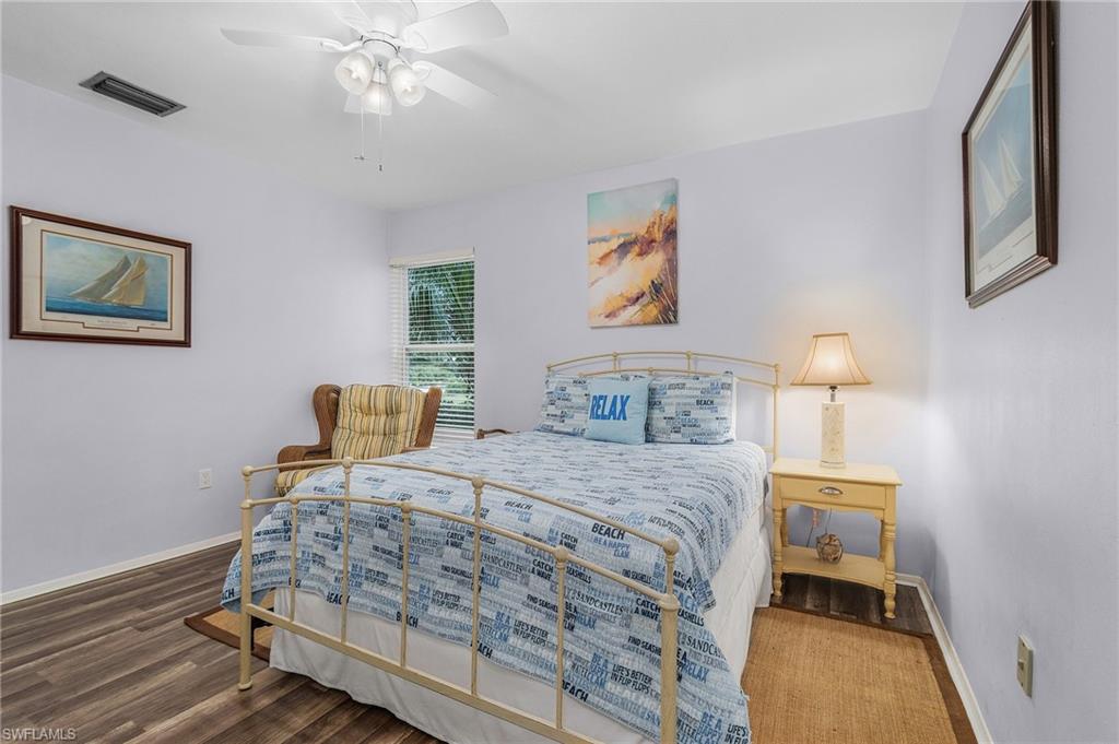 1281 10th Street North Naples, FL 34102 - Photo 20 of 31 Bedroom featuring wood finished floors and ceiling fan