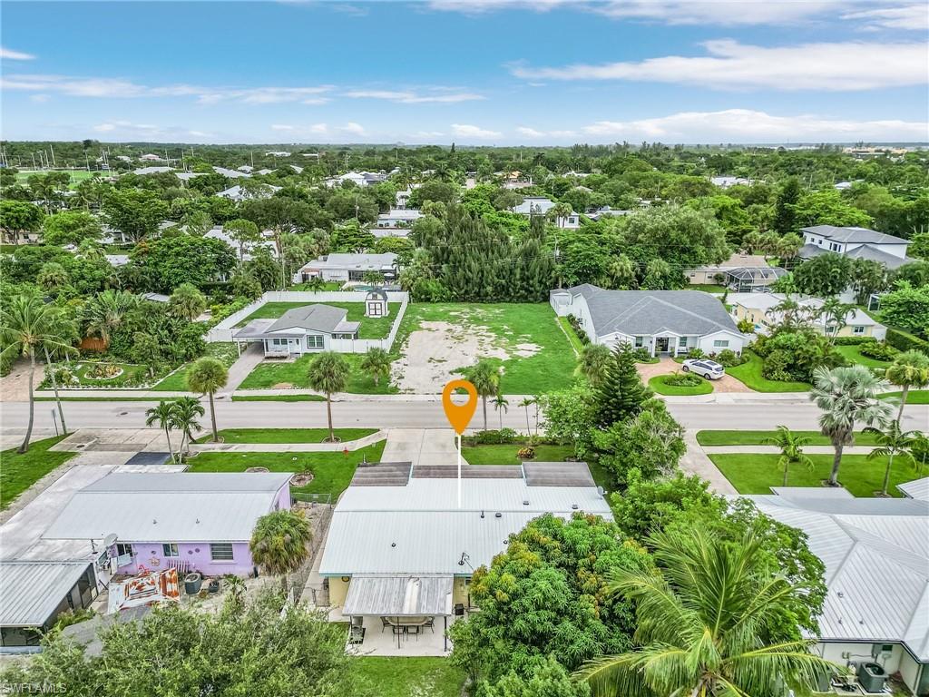 1281 10th Street North Naples, FL 34102 - Photo 28 of 31 Aerial perspective of suburban area featuring a tree filled landscape
