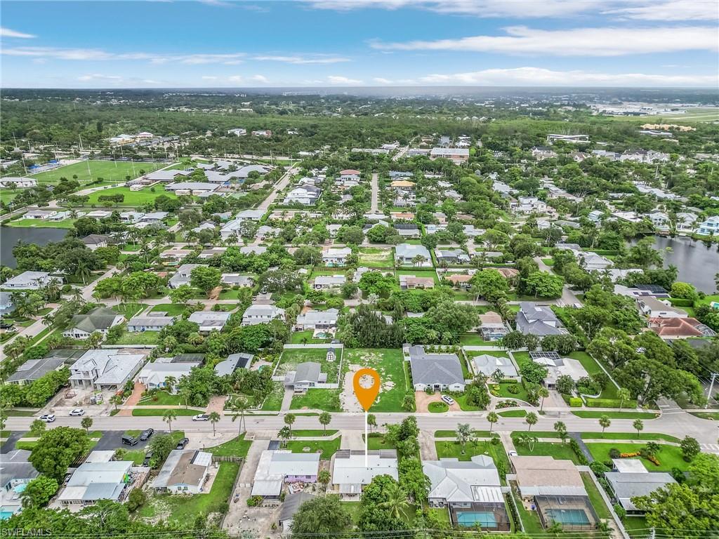 1281 10th Street North Naples, FL 34102 - Photo 30 of 31 Aerial overview of property's location featuring nearby suburban area and a large body of water
