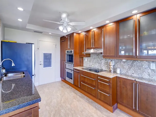 a kitchen with stainless steel appliances granite countertop a sink and cabinets