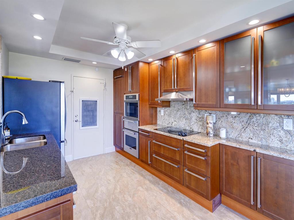2500 East Las Olas Boulevard, Unit 901 Fort Lauderdale, FL 33301 - Photo 20 of 44 a kitchen with stainless steel appliances granite countertop a sink and cabinets