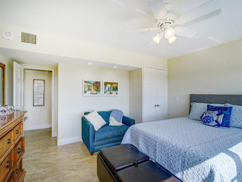 2500 East Las Olas Boulevard, Unit 901 Fort Lauderdale, FL 33301 - Photo 23 of 44 a bedroom with a bed and a chandelier