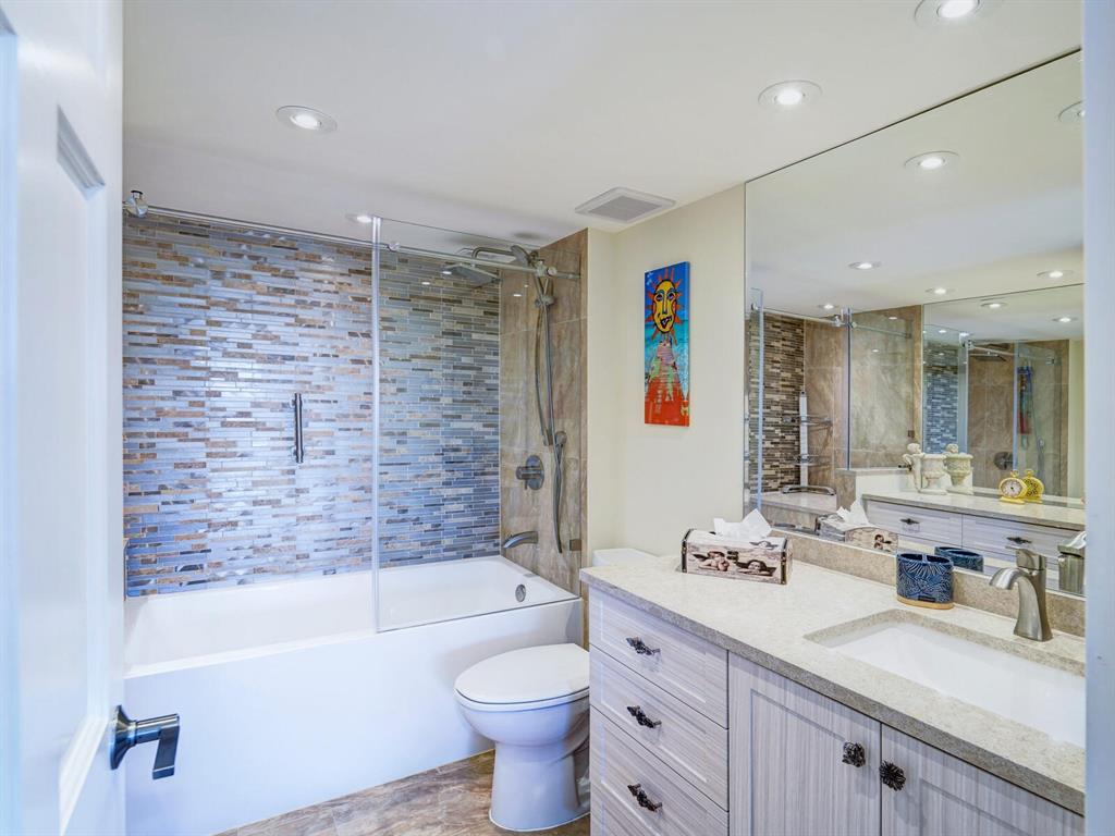 2500 East Las Olas Boulevard, Unit 901 Fort Lauderdale, FL 33301 - Photo 26 of 44 a bathroom with a granite countertop sink toilet mirror and bathtub