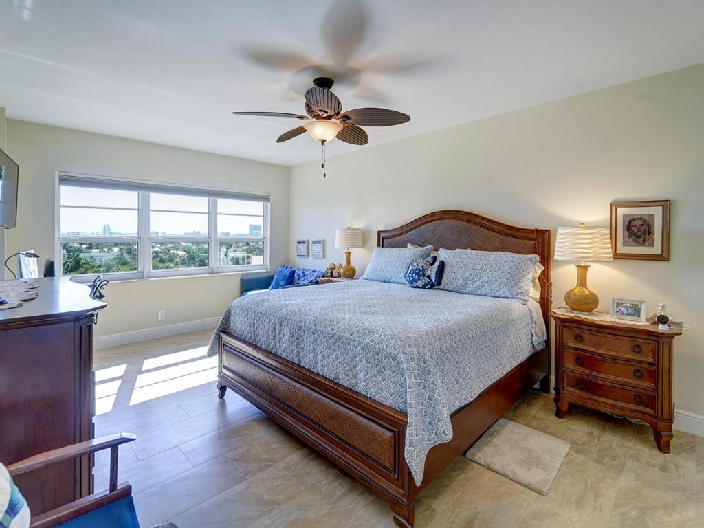 2500 East Las Olas Boulevard, Unit 901 Fort Lauderdale, FL 33301 - Photo 28 of 44 a bedroom with a large bed and a chandelier fan