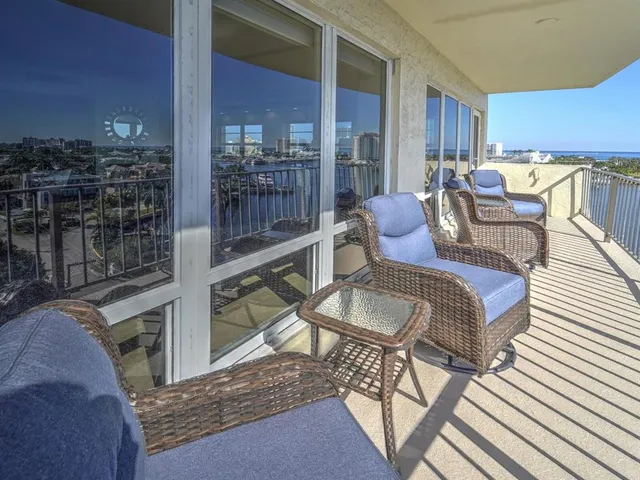 a view of a chairs and table in the balcony