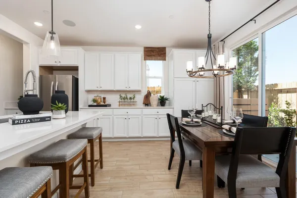 a kitchen with stainless steel appliances granite countertop a sink a stove a refrigerator and island with wooden floor
