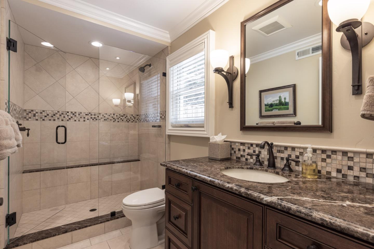 3125 Bird Rock Road Pebble Beach, CA 93953 - Photo 17 of 35 a bathroom with a granite countertop sink toilet and shower