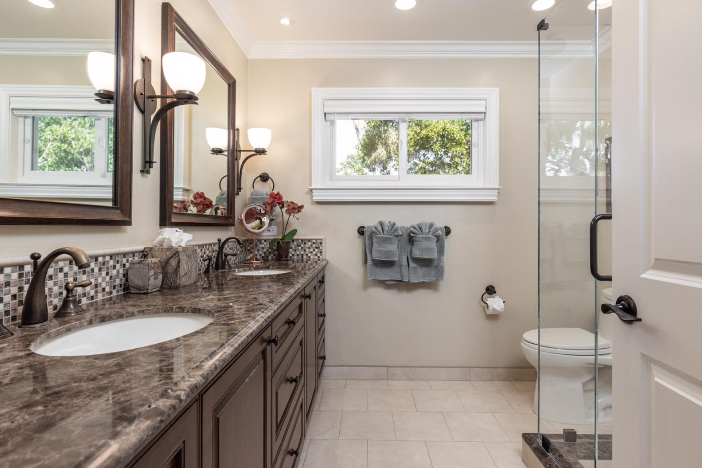 3125 Bird Rock Road Pebble Beach, CA 93953 - Photo 20 of 35 a bathroom with a granite countertop sink a toilet and a mirror