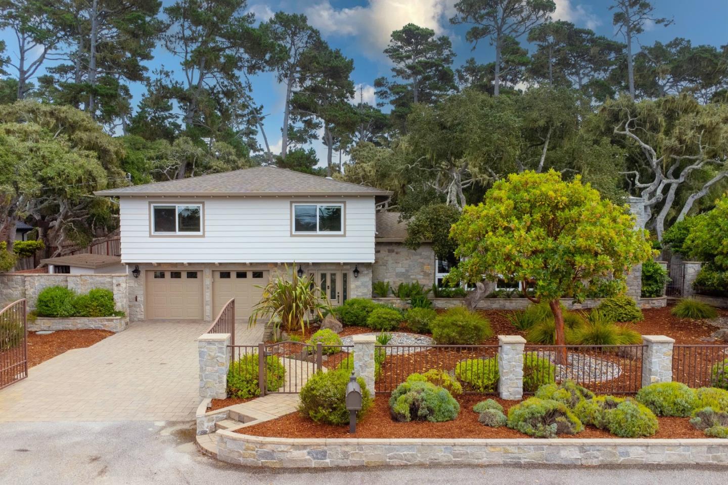 3125 Bird Rock Road Pebble Beach, CA 93953 - Photo 2 of 35 a front view of a house with garden