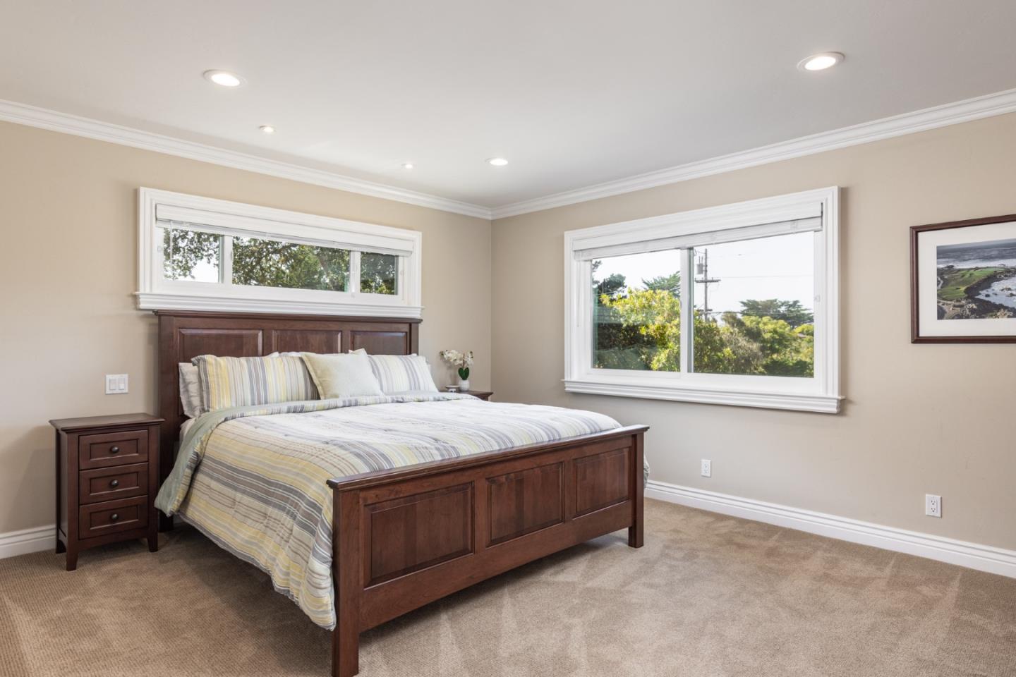 3125 Bird Rock Road Pebble Beach, CA 93953 - Photo 21 of 35 a bedroom with a bed lamp and window