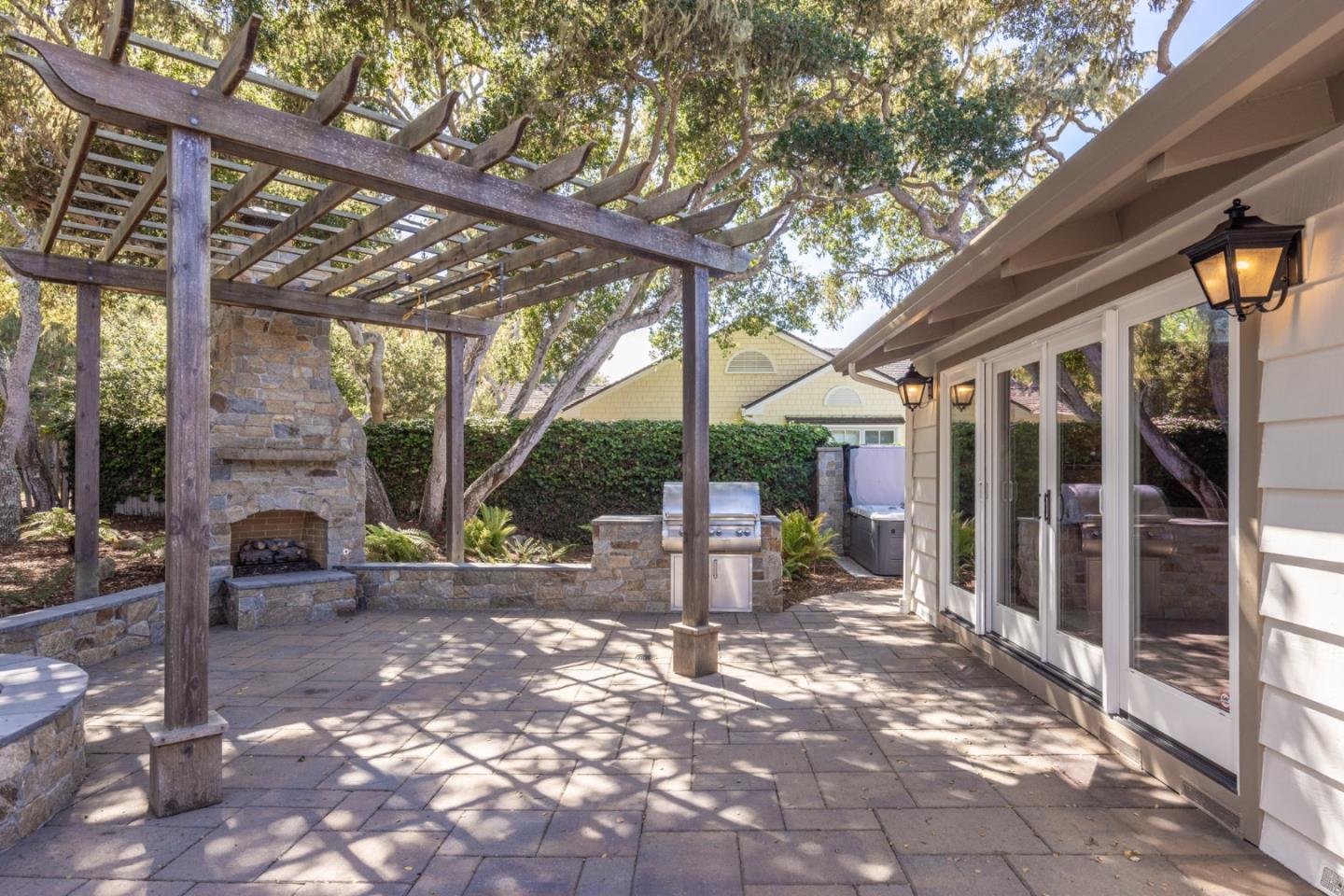 3125 Bird Rock Road Pebble Beach, CA 93953 - Photo 25 of 35 a view of a patio with table and chairs and potted plants
